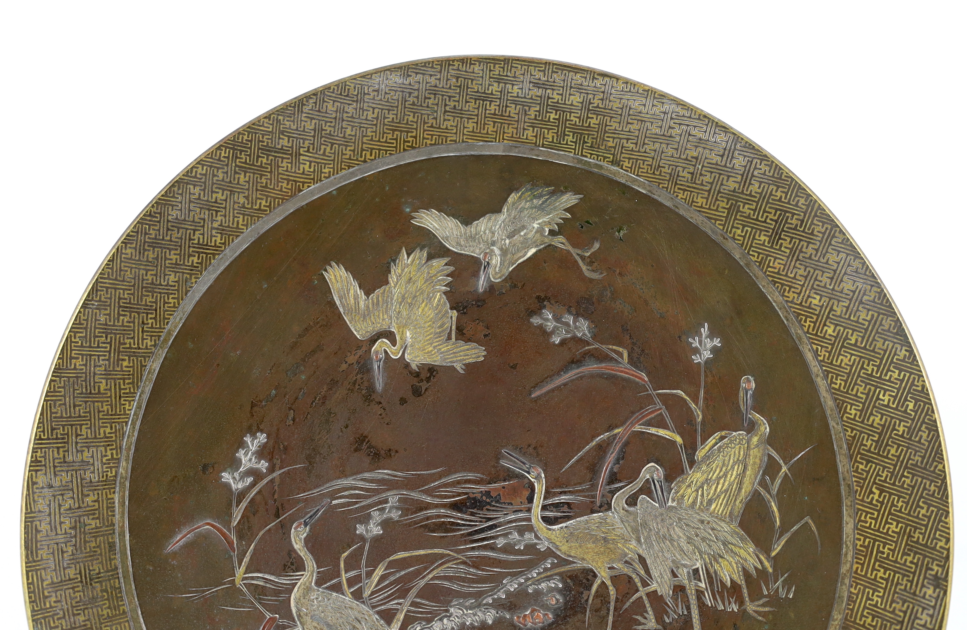 A Japanese Komai style mixed metal inlaid bronze dish, Meiji period